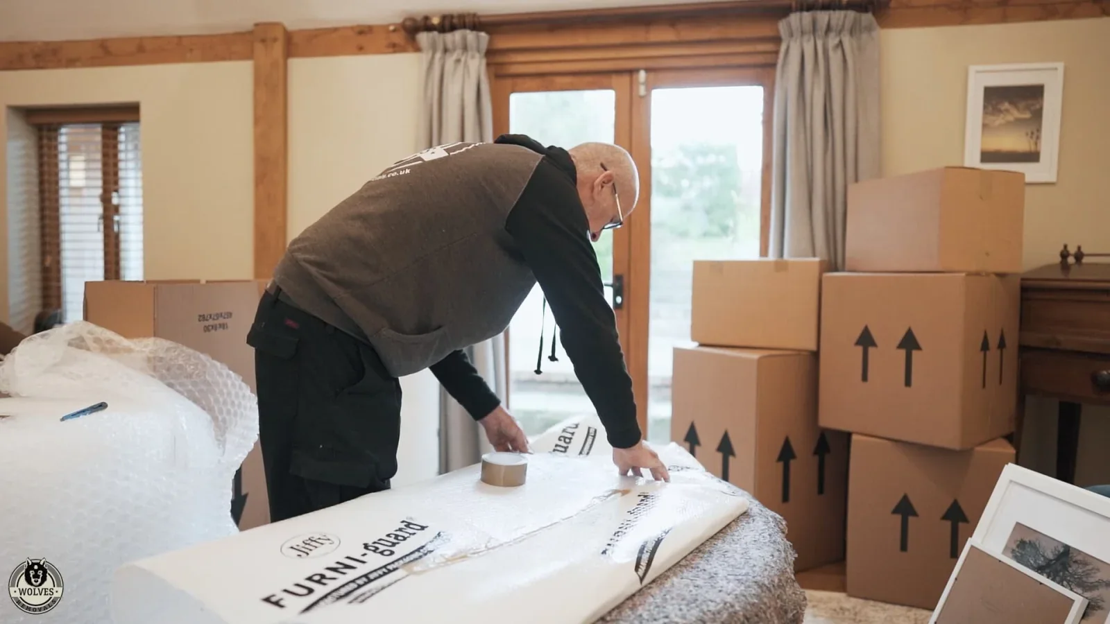 Wolves Storage Sussex packer wrapping furniture in Furni-guard padding before secure storage