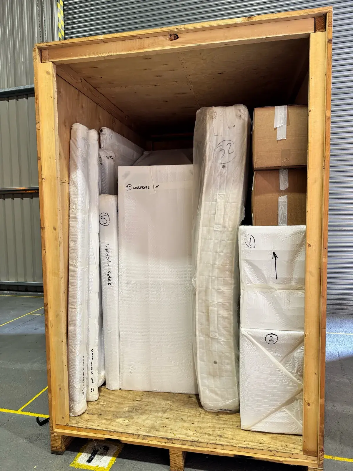Short-term storage container neatly packed with wrapped furniture by Wolves Storage Sussex