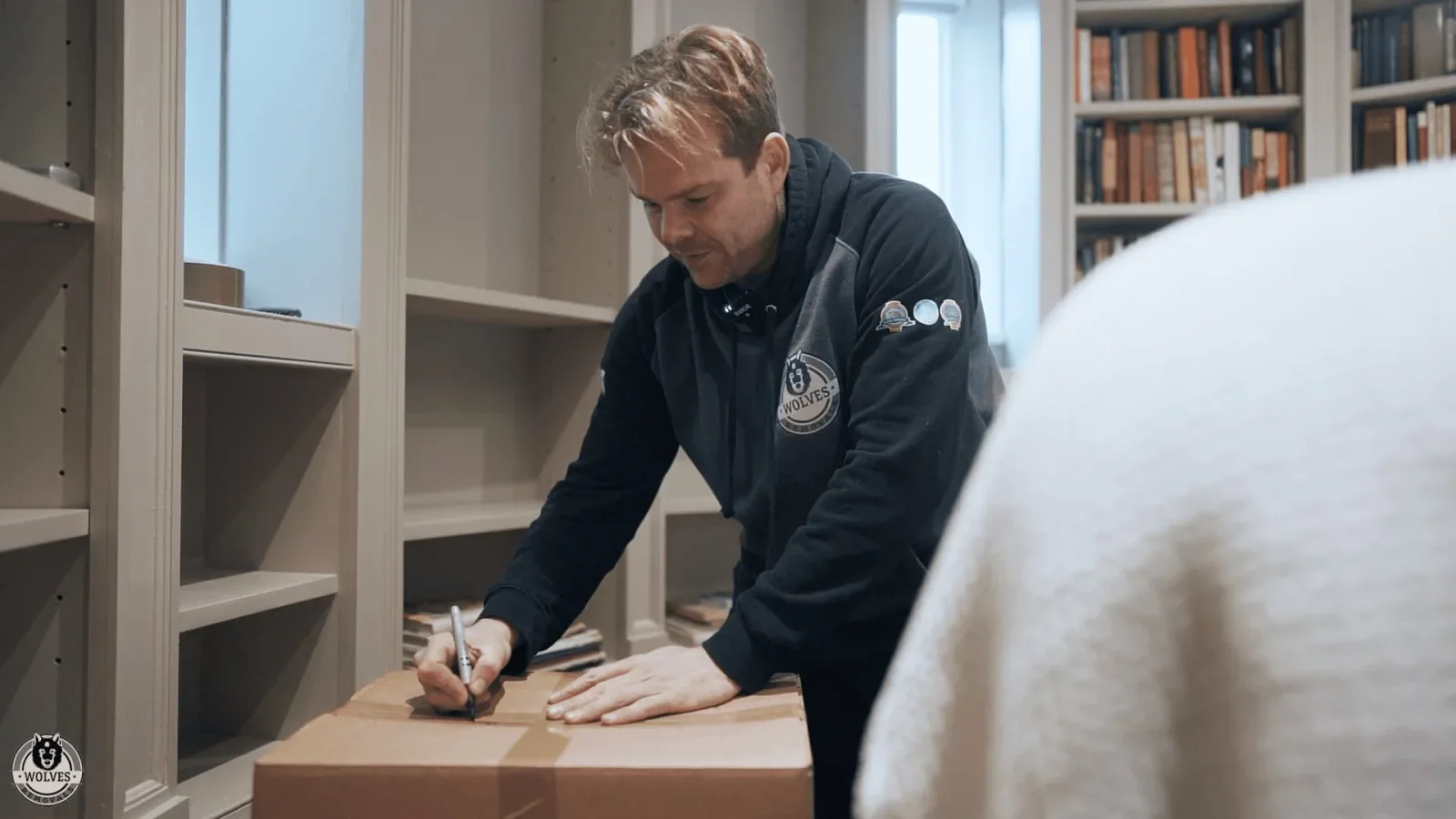 Wolves Storage Sussex packer labelling a carefully packed box during a professional home pack — storage in East Grinstead, West Sussex