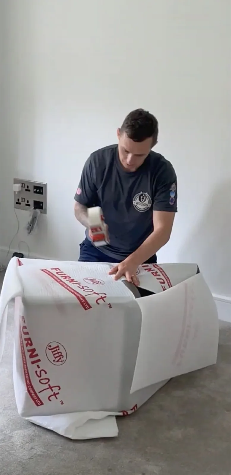 Wrapping furniture in Furni-soft padding before sealing it into a storage container — Wolves Storage Sussex serving Pulborough