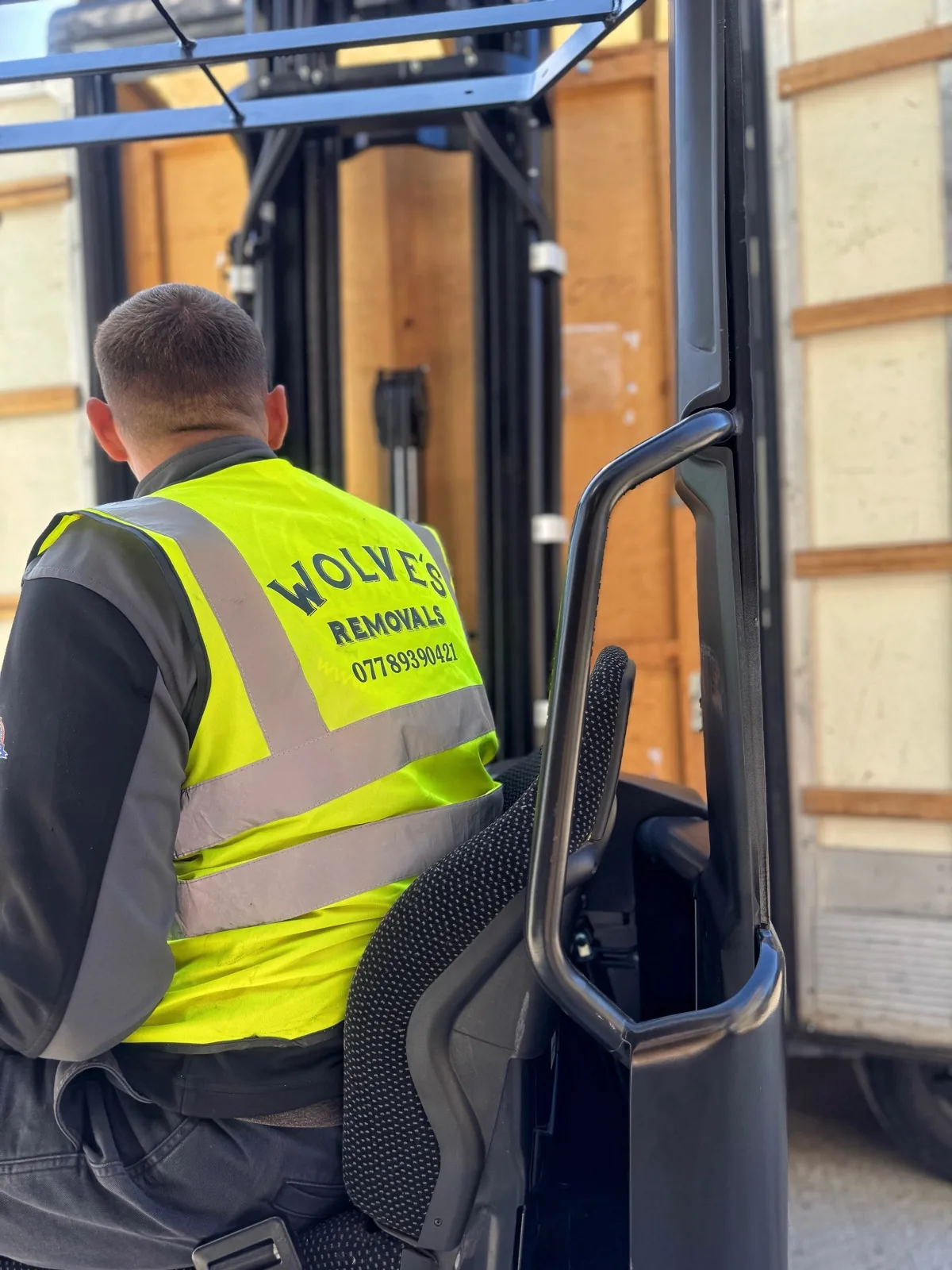 A Wolves Storage Sussex operator moving sealed storage containers by forklift in our secure West Sussex warehouse